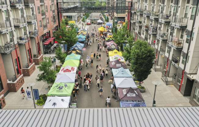 an aerial view of a city street filled with people and vendors