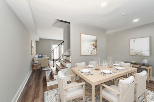 a dining room with a wooden table and chairs