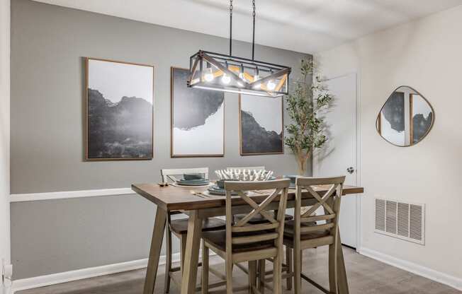 our spacious dining room with a table and chairs and a chandelier