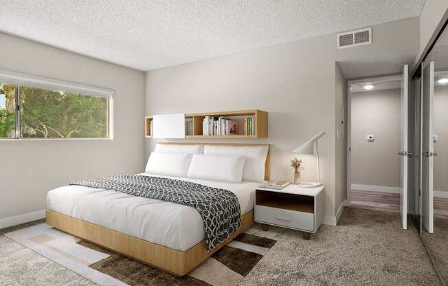 Carpeted bedroom with large window for natural light.