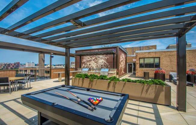 A pool table is set up on a patio.
