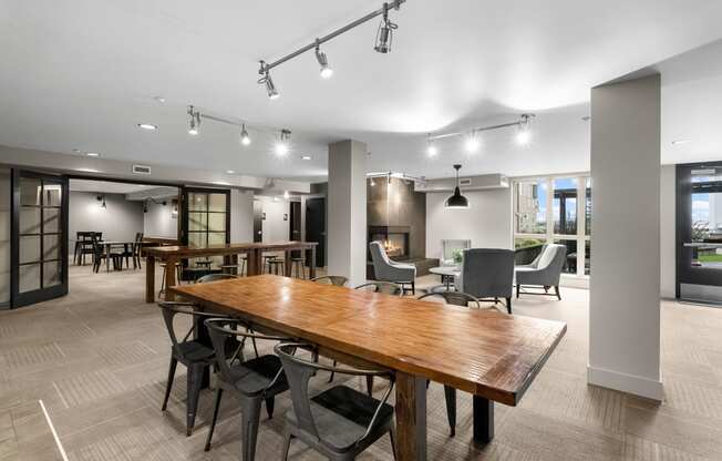 a communal area with tables and chairs and a fireplace