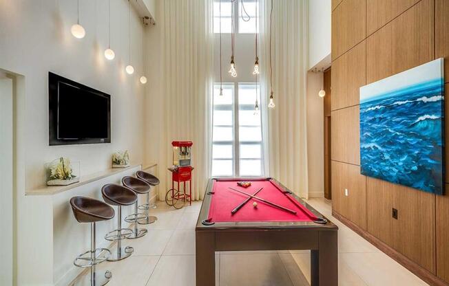 a pool table in a living room with a tv