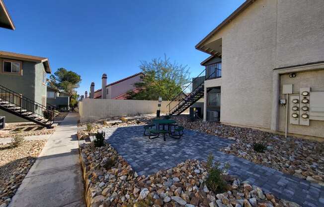 a courtyard with a picnic table in front of a building