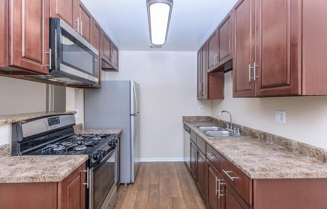 a kitchen with stainless steel appliances and wooden cabinets