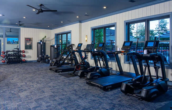 A gym with treadmills and exercise bikes.