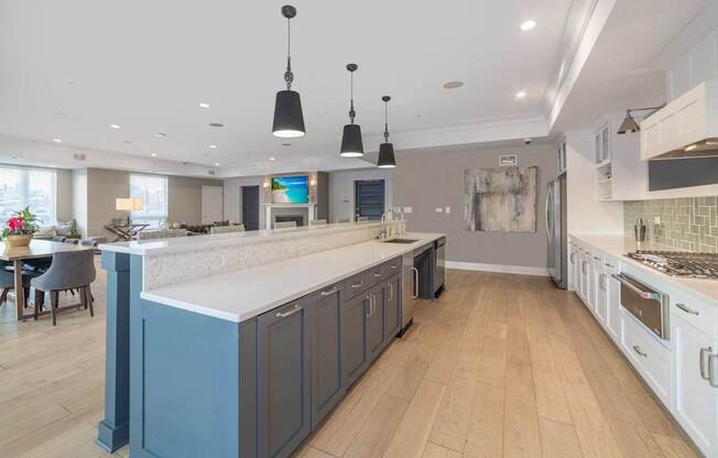 A kitchen with a large island and wooden floors.