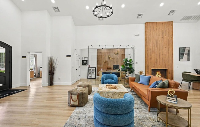 A living room with a blue chair and a fireplace.