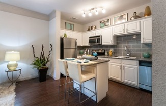 This is a photo of the kitchen in the 826 square foot 1 bedroom , 1 bath apartment at The Brownstones Townhome Apartments in Dallas, TX.