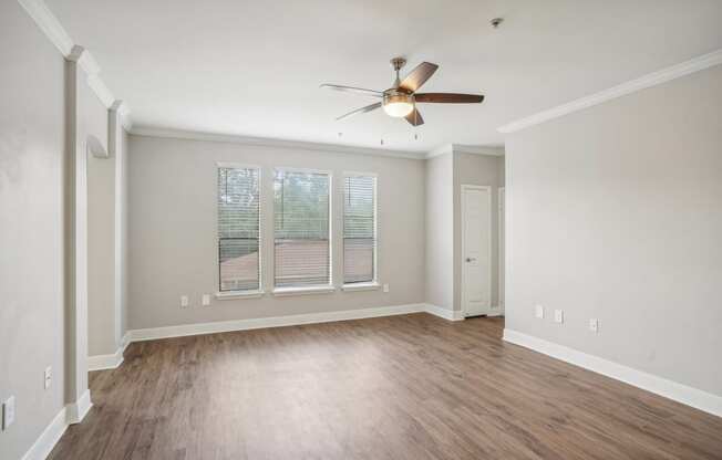 an empty living room with a ceiling fan and a window  at The Verandah, Austin, TX, 78726