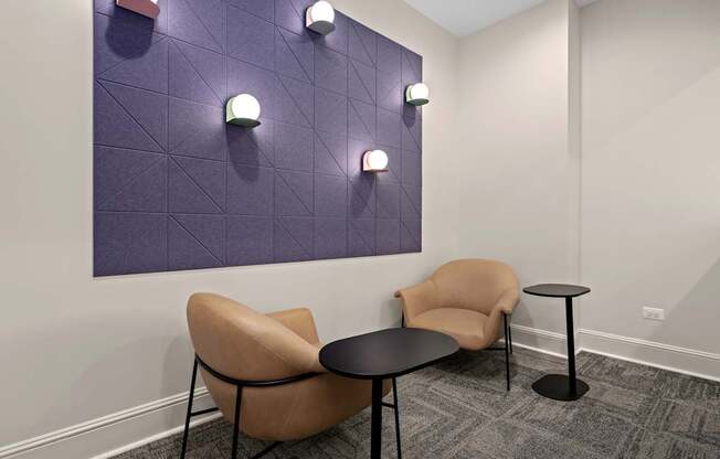 A purple wall with lights and a tan chair.