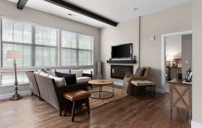 a living room with a couch and chairs and a fireplace at Hayden Lofts, Ohio