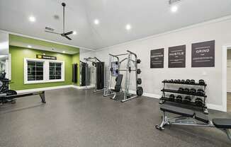 Community Fitness Center with Equipment at Bridges at Oakbend Apartments located in Lewisville, TX.