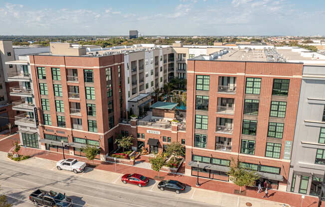 A street view of a city with cars and buildings.