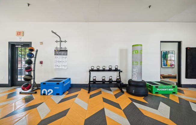 a fitness room with weights and other gym equipment