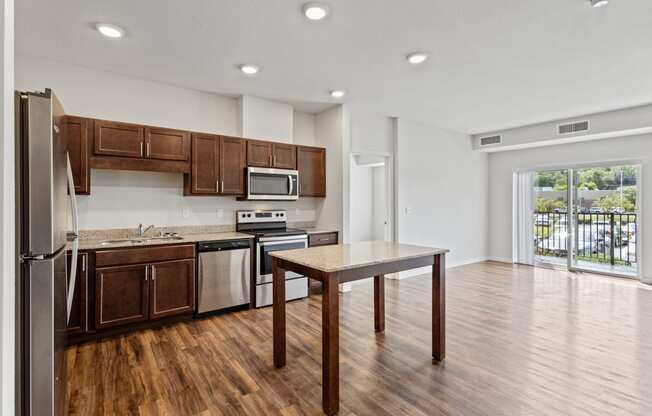 a kitchen with wooden cabinets and stainless steel appliances and a table