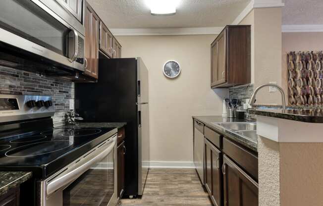 a kitchen with wooden cabinets and black appliances