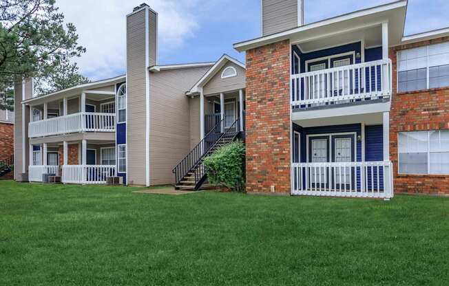 a view of a building with green grass in front of it at The Davis Apartments, Huntsville  