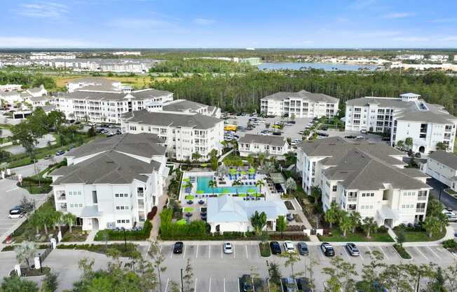 an aerial view of a large group of houses and a swimming pool