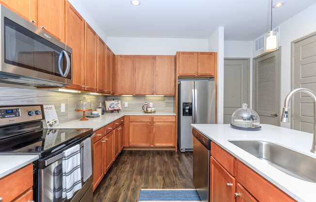 a kitchen with wooden cabinets and stainless steel appliances