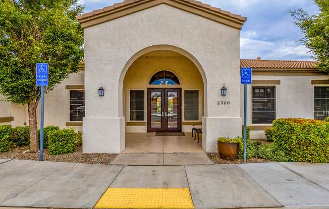 the front door of a building with two blue signs on either side of the door