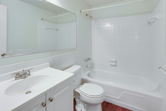 a bathroom with a sink toilet and a bath tub