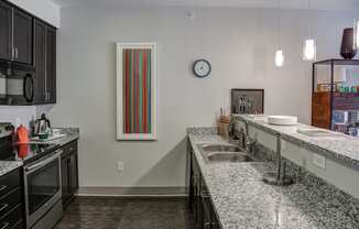 Kitchen with granite counter tops and a sink at Heritage at Oakley Square, Ohio, 45209