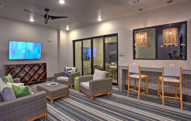a living room with a table and chairs and a television at Hunters Creek Apartments, Texas, 76210