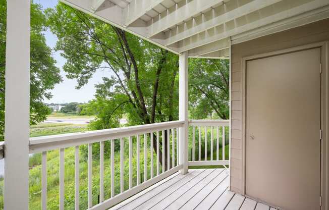 the view from the deck of a house with a door open to a porch