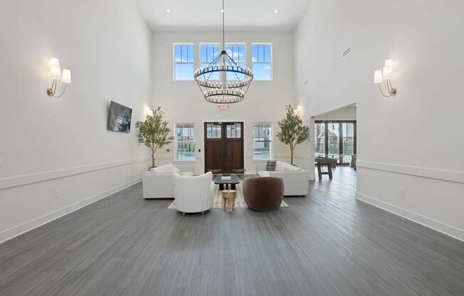 a living room with couches and chairs and a chandelier