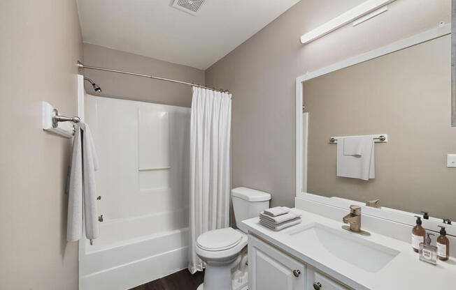 Model bathroom with white vanity at Vue at Baymeadows Apartments in Jacksonville, Florida