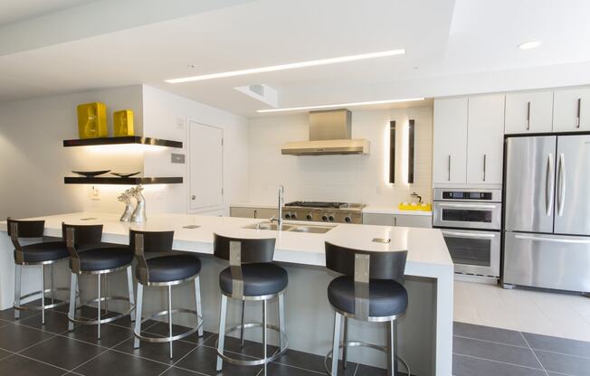 a kitchen with white cabinets and a island with a white countertop