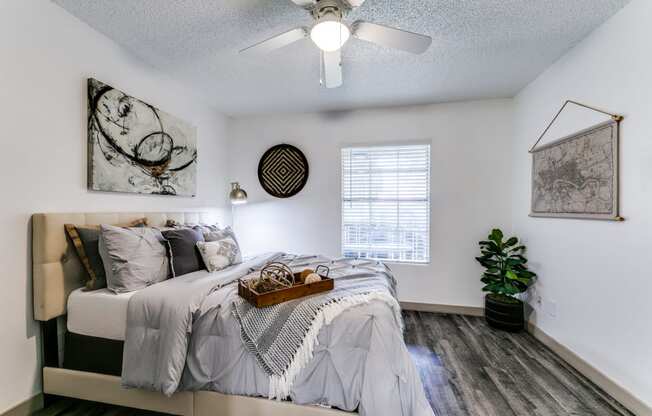 an attic bedroom with a bed and a ceiling fan