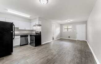 an empty living room with a kitchen in the background  at Balfour 296, Lilburn, 30047