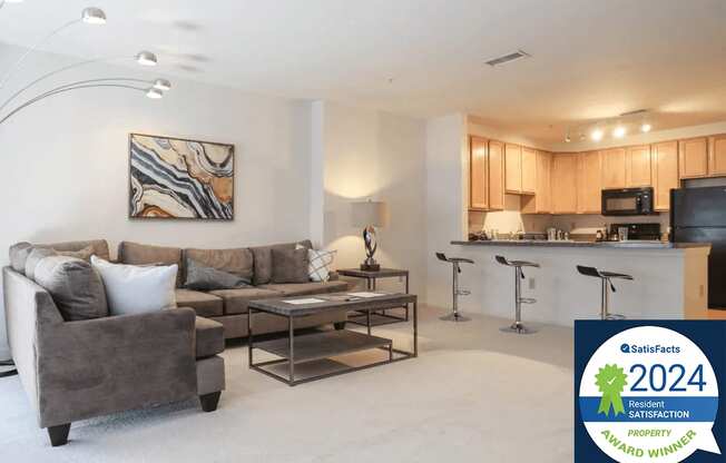 Symphony Center Apartments Living Room Interior with Resident Satisfaction Award Logo Banner