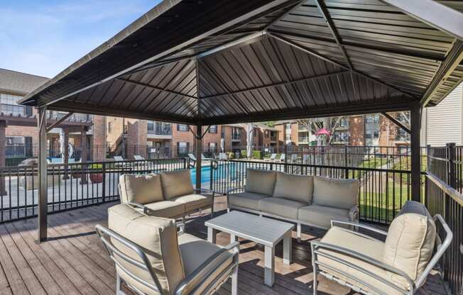 a patio with couches and chairs and a table