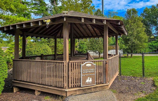 a wooden gazebo with a sign on it