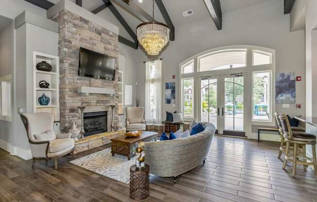 the living room has a large stone fireplace and a large window