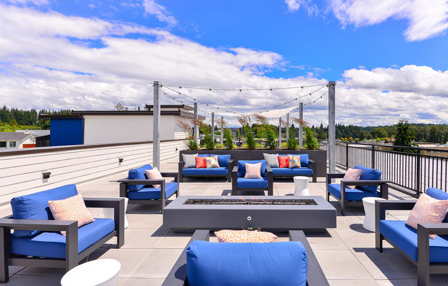 Apartments for Rent in Bothell - Community Rooftop Lounge Area with Plush Seating, Tables, and Aesthetic Lighting