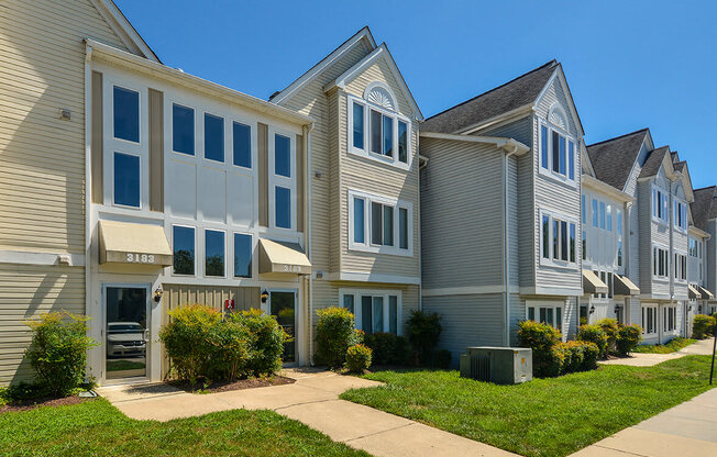 a row of houses with a sidewalk in front of them