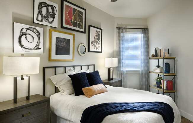 a bedroom with a bed and pictures on the wall