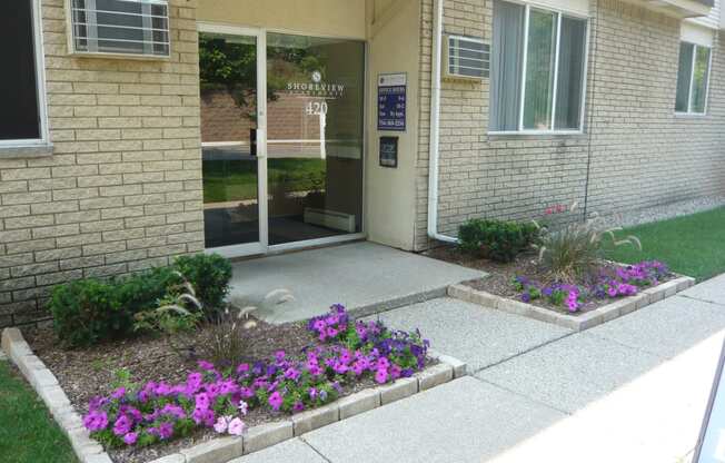 Shoreview Apartments leasing office exterior entryway with landscaping