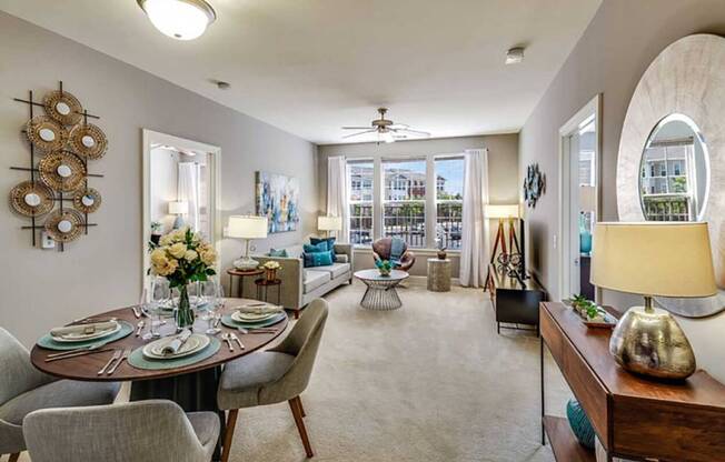 a living room and dining room with a table and chairs