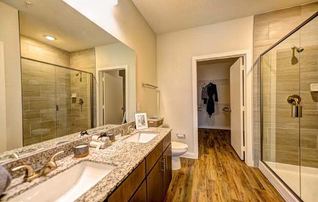 a bathroom with a large mirror and a toilet  at Fusion, Jacksonville, FL, 32256