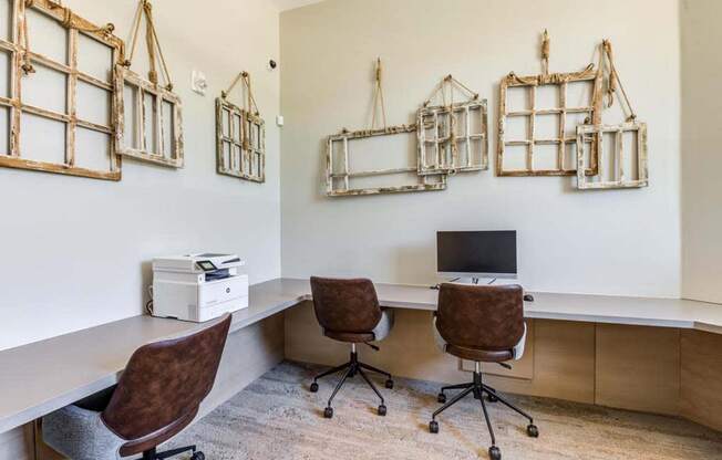 an office with two chairs and a computer at The Vineyards Apartments, Porter Ranch, CA