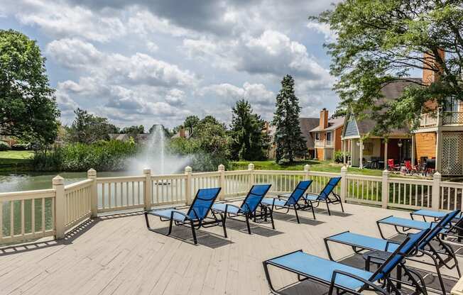 Westerville, OH Apartments - Fairway Lakes - Sundeck with Lounge Seating Overlooking Large Pond with Water Fountain.