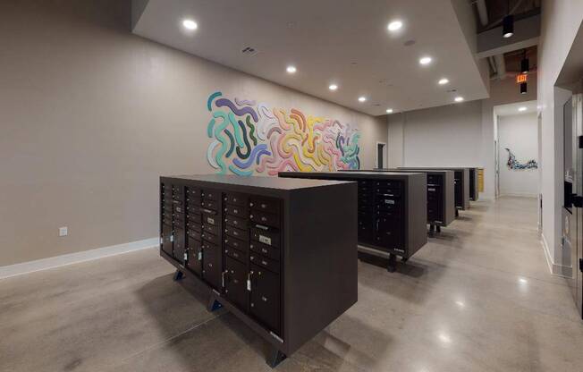 Mail room and dry cleaning lockers at Modera Washington, featuring unique art (you'll find more throughout the community).