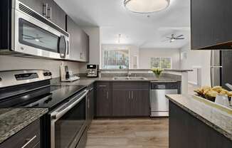 a kitchen with stainless steel appliances and granite counter tops