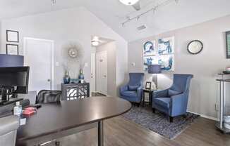 a living room with a table and chairs