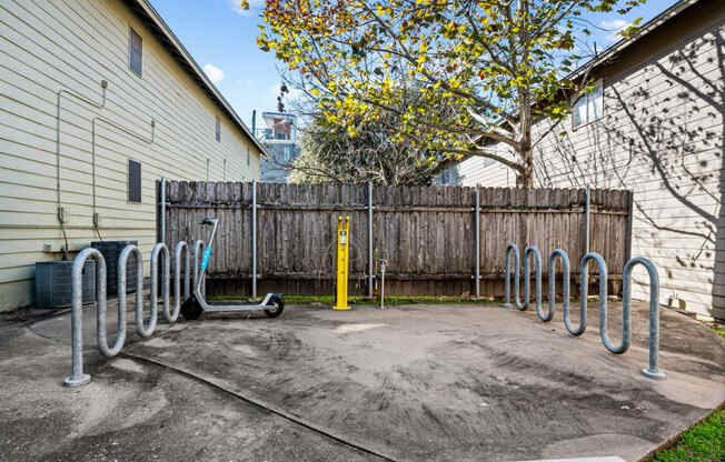 the back yard of a house with a bike rack and a fence